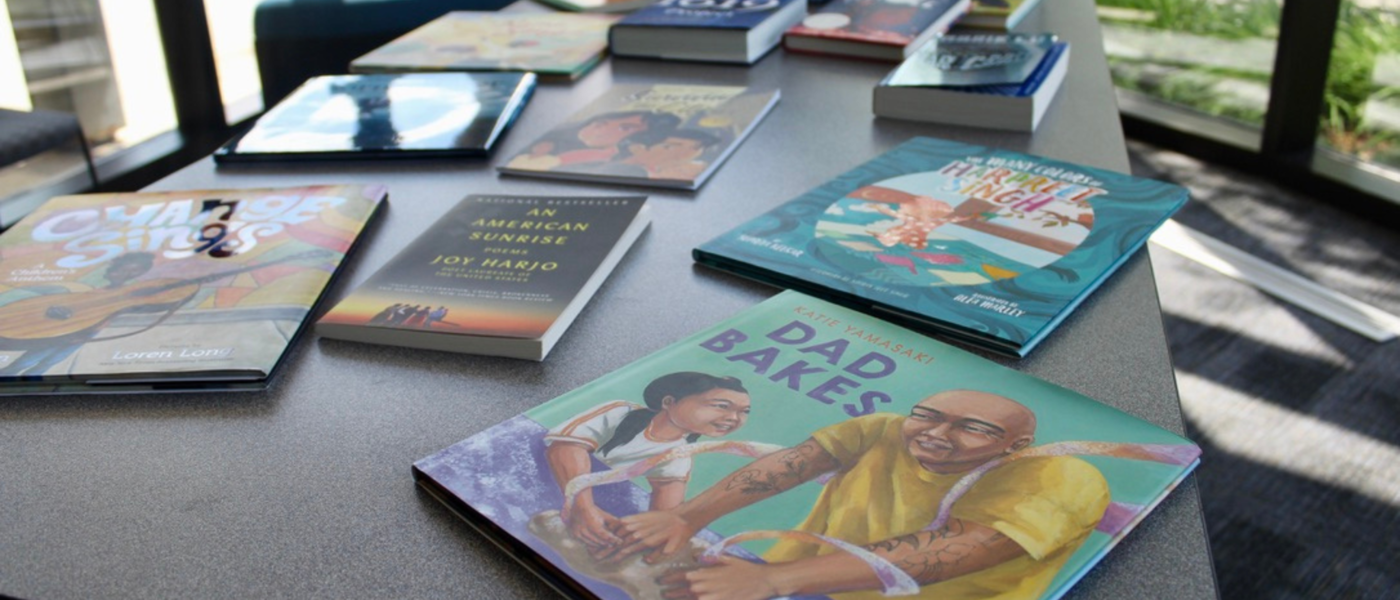 Diverse books available to educators and classrooms are displayed on a table.