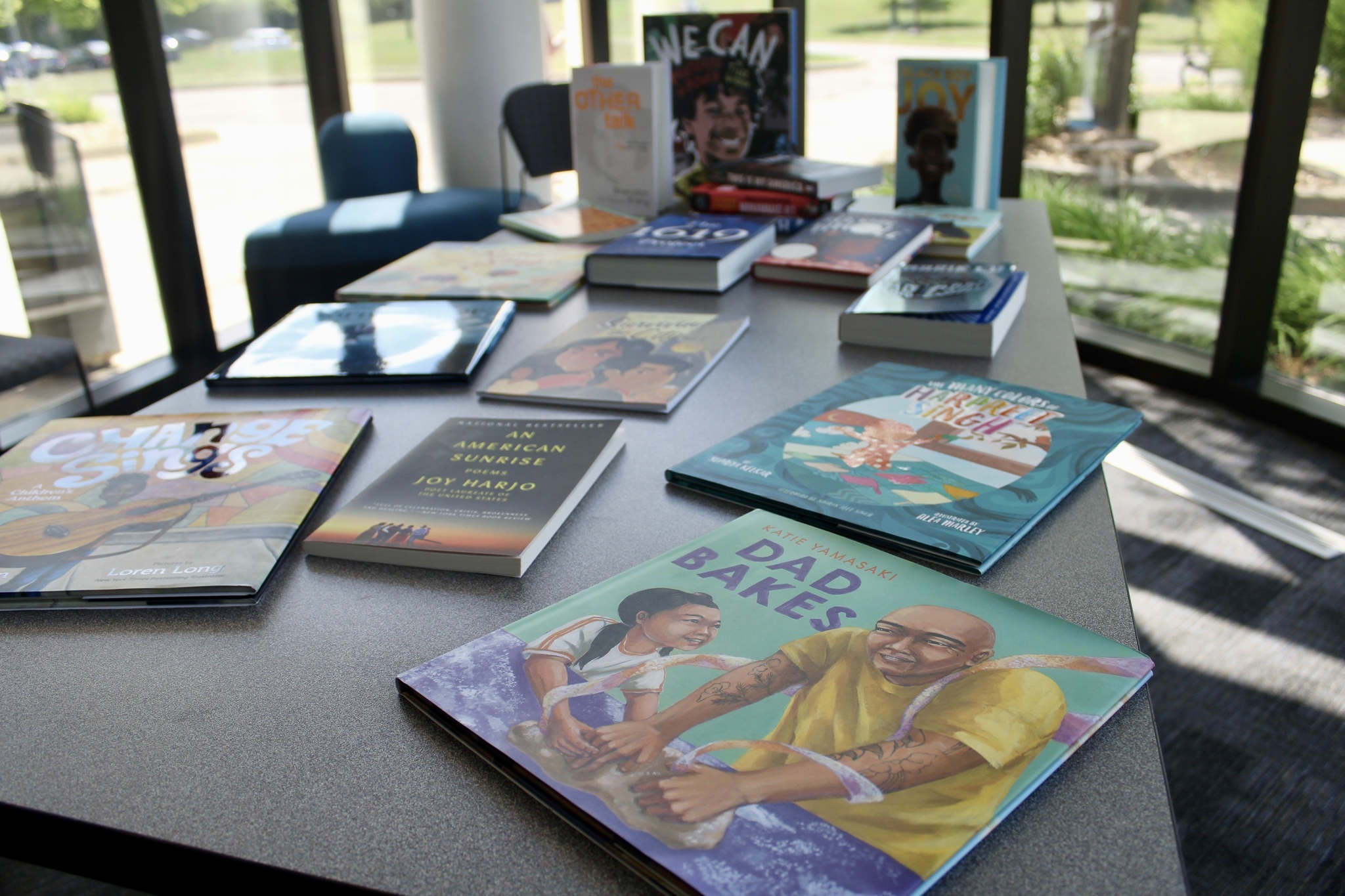 Books about diverse stories are displayed laying flat on a table.
